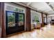 Living space featuring double glass doors to deck, large windows, and hardwood flooring at 5 Coventry Close, Avondale Estates, GA 30002