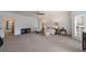 Spacious living room with patterned carpet, ceiling fan, and bright windows at 5 Coventry Close, Avondale Estates, GA 30002