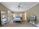 Relaxing main bedroom with carpet, arched windows with plantation shutters, and a large mirror at 5 Coventry Close, Avondale Estates, GA 30002