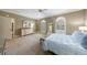 Bright main bedroom with carpeted floors, arched windows with plantation shutters, and neutral wall color at 5 Coventry Close, Avondale Estates, GA 30002