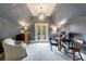 Home office with chandelier, desk, chair, and outdoor access through glass doors at 5 Coventry Close, Avondale Estates, GA 30002