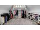 Spacious walk-in closet with custom shelving, hanging rods, and built-in cabinets at 5 Coventry Close, Avondale Estates, GA 30002
