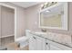 Bright bathroom featuring granite countertop, white vanity, and a large mirror at 279 Alex St, Canton, GA 30114