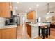 Bright kitchen featuring tile floors, wooden cabinetry and a central island with breakfast bar seating at 146 Saint Margrit Cir, Stockbridge, GA 30281