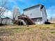 View of the backyard with a deck, grassy area, and a walkout basement at 3520 Newberry Ln, Douglasville, GA 30135