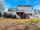 Home featuring a backyard with a deck and stairs, offering seamless indoor-outdoor living at 3520 Newberry Ln, Douglasville, GA 30135