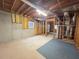 Unfinished basement with concrete flooring and exposed ceiling with natural light entering from a window at 3520 Newberry Ln, Douglasville, GA 30135