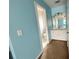 Bright bathroom featuring blue walls, a white vanity with sink, and a view into the toilet area at 3520 Newberry Ln, Douglasville, GA 30135