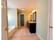 Bathroom featuring a double vanity, tiled floor and tub at 3520 Newberry Ln, Douglasville, GA 30135