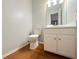 Bathroom featuring hardwood floors, a white toilet, and a white vanity with a sink at 3520 Newberry Ln, Douglasville, GA 30135
