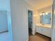 Bathroom featuring a vanity and mirror with access to a walk-in closet with shelving at 3520 Newberry Ln, Douglasville, GA 30135