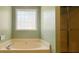 Bathroom showcasing a bathtub and tiled shower behind glass door at 3520 Newberry Ln, Douglasville, GA 30135