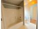Clean bathroom with a tub and shower combination, next to a toilet and door to a another room at 3520 Newberry Ln, Douglasville, GA 30135