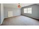 Bright bedroom featuring neutral walls, carpet flooring, a window, and an interesting light fixture at 3520 Newberry Ln, Douglasville, GA 30135
