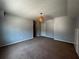 Large bedroom showcasing neutral walls, carpet flooring, and a decorative hanging light fixture at 3520 Newberry Ln, Douglasville, GA 30135