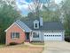 Charming single-Gathering home boasts a brick facade, two-car garage, and well-manicured lawn at 3520 Newberry Ln, Douglasville, GA 30135