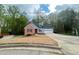Traditional home with a brick and vinyl exterior, attached garage, and a long driveway at 3520 Newberry Ln, Douglasville, GA 30135