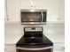 Kitchen featuring stainless steel appliances, including a microwave and range at 3520 Newberry Ln, Douglasville, GA 30135