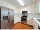 Modern kitchen featuring stainless steel appliances, white cabinets, and ample counter space at 3520 Newberry Ln, Douglasville, GA 30135