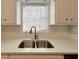 Close up of kitchen sink with window and updated countertops at 3520 Newberry Ln, Douglasville, GA 30135