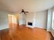 Inviting living room featuring hardwood floors, a ceiling fan, and a cozy fireplace at 3520 Newberry Ln, Douglasville, GA 30135