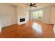 Bright living room featuring hardwood floors, a ceiling fan, and a cozy fireplace at 3520 Newberry Ln, Douglasville, GA 30135
