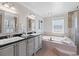 Bright bathroom with double vanity, soaking tub, and a separate glass shower at 6265 Reives Rd, Cumming, GA 30041