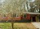 Charming brick home with a carport and flowering tree in the front yard; a delightful property at 2143 Rhinehill Se Rd, Atlanta, GA 30315