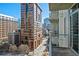 Balcony view of a bustling urban setting, dominated by a large, brown-brick office building at 44 Peachtree Nw Pl # 1328, Atlanta, GA 30309