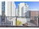 Balcony provides an urban view of modern white buildings and lush greenery at 44 Peachtree Nw Pl # 1328, Atlanta, GA 30309
