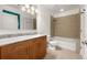 Well-lit bathroom features granite counters, updated fixtures, and a tiled shower-over-tub at 44 Peachtree Nw Pl # 1328, Atlanta, GA 30309
