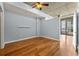 Bedroom with hard wood floors, ceiling fan, balcony access, and light-blue walls at 44 Peachtree Nw Pl # 1328, Atlanta, GA 30309
