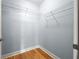 Walk-in closet with wood floor and metal shelving at 44 Peachtree Nw Pl # 1328, Atlanta, GA 30309