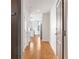 Hallway with hardwood floors leads to an open, modern kitchen and living area at 44 Peachtree Nw Pl # 1328, Atlanta, GA 30309