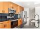 Modern kitchen featuring wooden cabinetry, stainless steel appliances, and dark countertops at 44 Peachtree Nw Pl # 1328, Atlanta, GA 30309