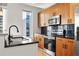 Modern kitchen with stainless steel appliances, granite countertops, and sleek wooden cabinets at 44 Peachtree Nw Pl # 1328, Atlanta, GA 30309