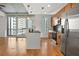 Sleek modern kitchen with stainless steel appliances, black countertops, and large windows showcasing city views at 44 Peachtree Nw Pl # 1328, Atlanta, GA 30309