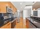 Modern kitchen with granite countertops, stainless steel appliances, and stylish dark backsplash at 44 Peachtree Nw Pl # 1328, Atlanta, GA 30309