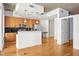 Modern living area with hardwood floors and kitchen with wooden cabinets and stainless steel appliances at 44 Peachtree Nw Pl # 1328, Atlanta, GA 30309