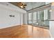 Bright and airy living room with large windows, hardwood floors, and city views from the balcony at 44 Peachtree Nw Pl # 1328, Atlanta, GA 30309
