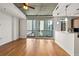 Spacious living area with hardwood floors, exposed concrete ceiling, and large windows overlooking city views at 44 Peachtree Nw Pl # 1328, Atlanta, GA 30309