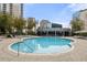 Relaxing outdoor pool area with lounge chairs and city views at 44 Peachtree Nw Pl # 1328, Atlanta, GA 30309