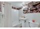 Charming bathroom features floral wallpaper, a pedestal sink, and a shower with a decorative curtain at 3510 Nw Roswell Nw Rd # J1, Atlanta, GA 30305