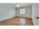 Bedroom featuring pale blue walls, hardwood floors, and a window that provides natural light, and a ceiling fan at 3510 Nw Roswell Nw Rd # J1, Atlanta, GA 30305