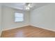 Bright bedroom with light hardwood floors, a window with blinds, and fresh paint offering a serene atmosphere at 3510 Nw Roswell Nw Rd # J1, Atlanta, GA 30305