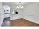 Bright dining area featuring hardwood floors, chandelier, and a view into the updated kitchen at 3510 Nw Roswell Nw Rd # J1, Atlanta, GA 30305