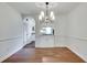 Classic dining room with hardwood floors, an elegant light fixture, and seamless flow into the kitchen at 3510 Nw Roswell Nw Rd # J1, Atlanta, GA 30305