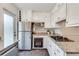 Well-lit kitchen showcasing stainless appliances, white cabinetry, and granite countertops at 3510 Nw Roswell Nw Rd # J1, Atlanta, GA 30305