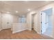 Open hallway with neutral walls, light wood flooring, white doors and trim at 4523 Moray Dr, Mableton, GA 30126