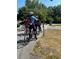 Group of cyclists stopped on side street beside lush green trees and a quiet neighborhood at 4523 Moray Dr, Mableton, GA 30126